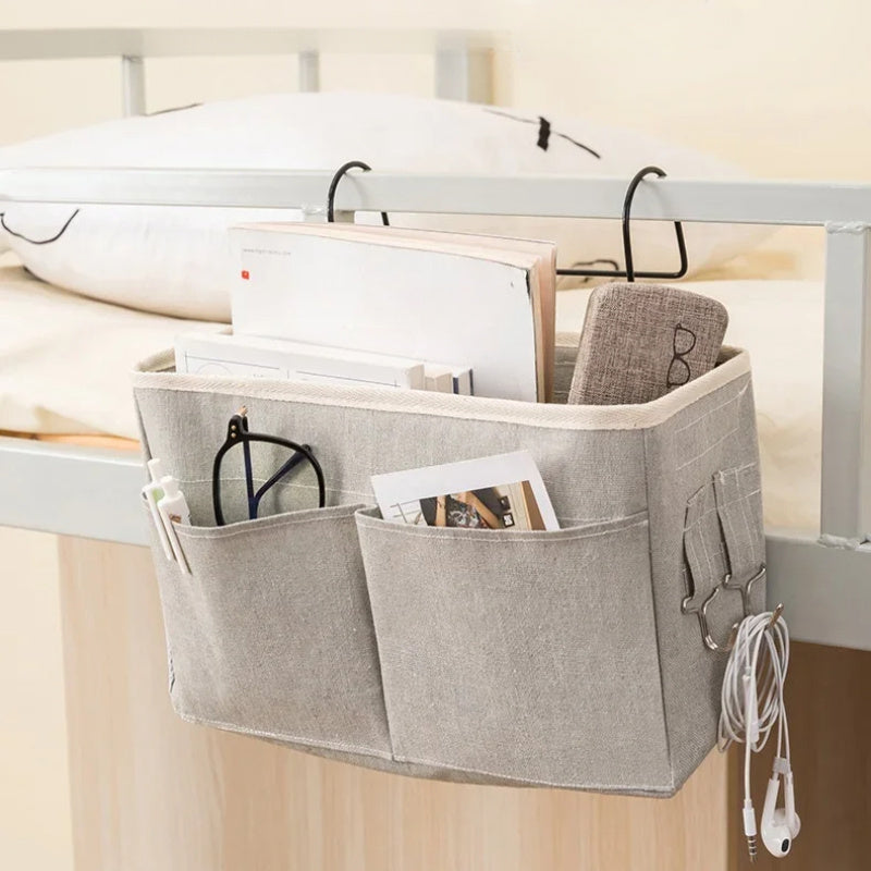 Portable hanging crib organizer for essential care items and bed accessories.