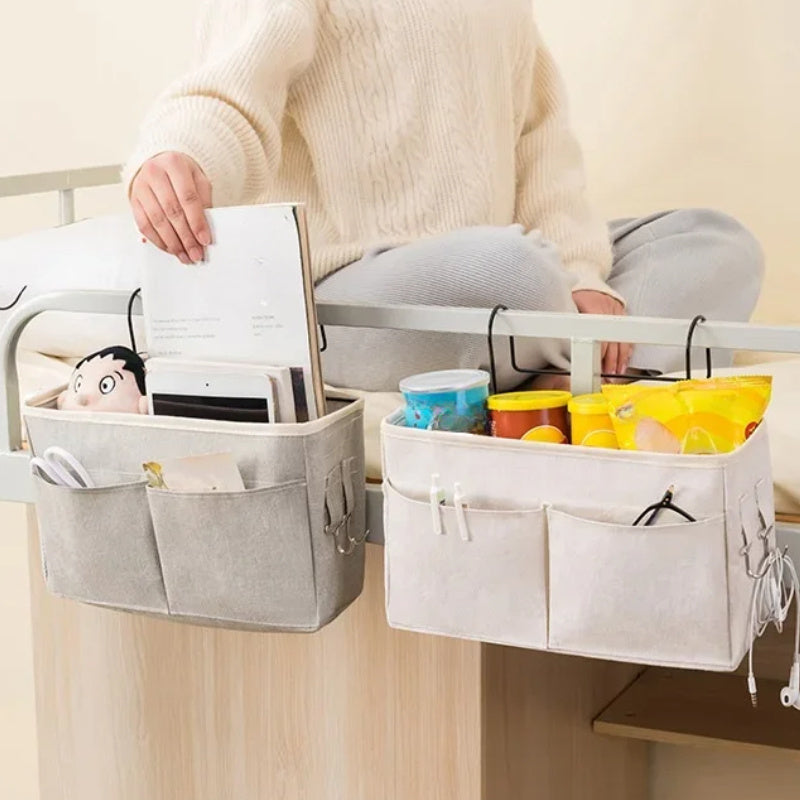 Portable hanging crib organizer for essential care items and bed accessories.