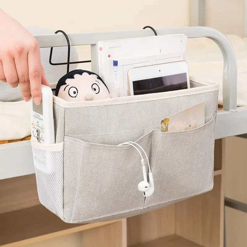 Portable hanging crib organizer for essential care items and bed accessories.