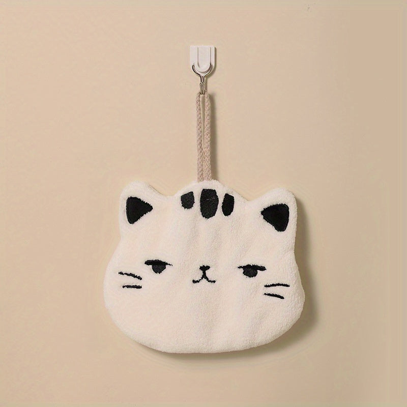 Cute cat-shaped hand towel made of soft coral fleece material with quick-dry feature, suitable for use in bathroom and kitchen with its hanging design.