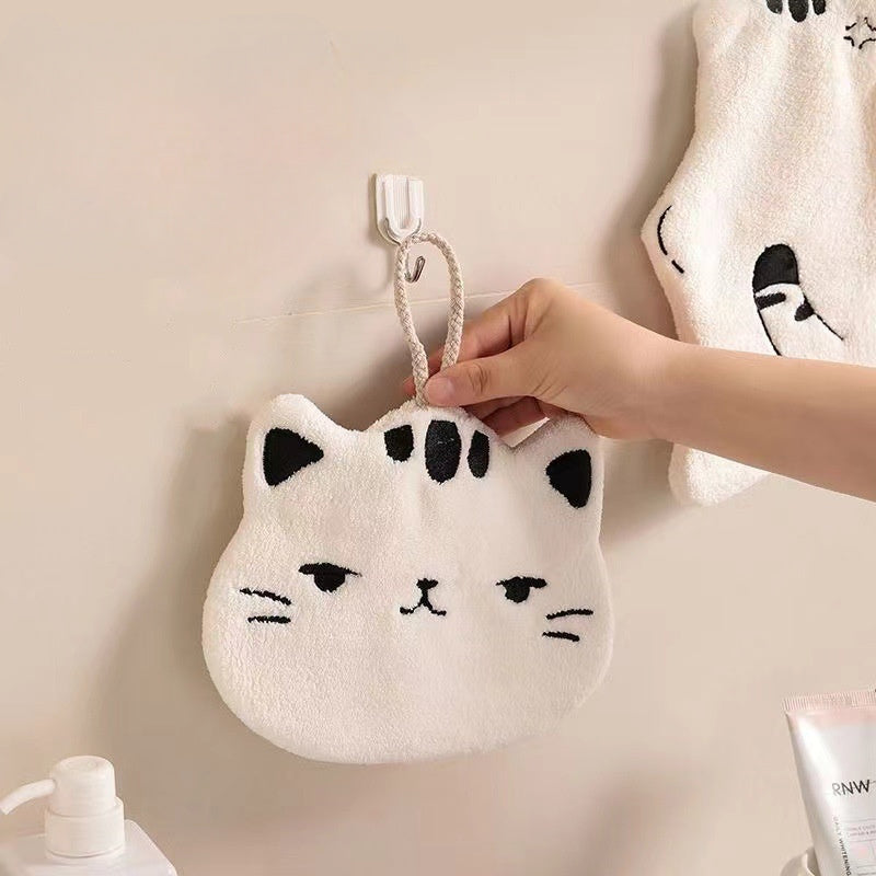 Cute cat-shaped hand towel made of soft coral fleece material with quick-dry feature, suitable for use in bathroom and kitchen with its hanging design.