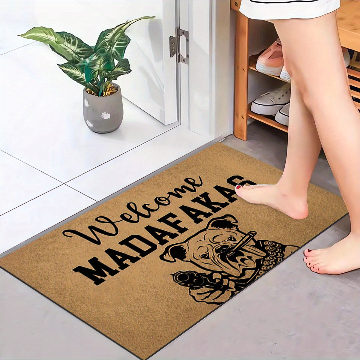 A unique welcome mat featuring a "Welcome Madafakas" design, complete with a dog holding a gun pattern. This anti-slip, absorbent mat is easy to clean and made of crystal velvet carpet material. Perfect for use in entrances, bedrooms, farms, and both