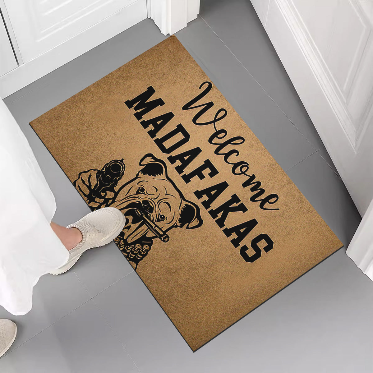 A unique welcome mat featuring a "Welcome Madafakas" design, complete with a dog holding a gun pattern. This anti-slip, absorbent mat is easy to clean and made of crystal velvet carpet material. Perfect for use in entrances, bedrooms, farms, and both