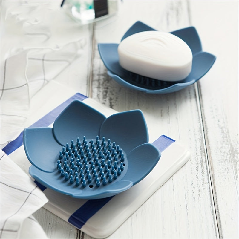 Silicone soap dish designed in the shape of a lotus flower, equipped with a drain for quick drying. Convenient and space-saving bathroom accessory.