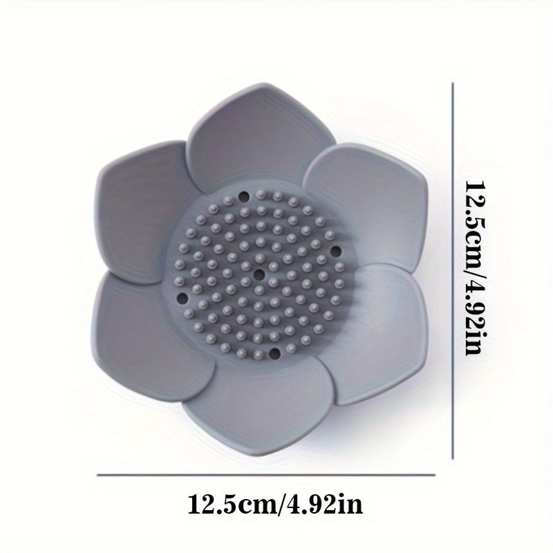 Silicone soap dish designed in the shape of a lotus flower, equipped with a drain for quick drying. Convenient and space-saving bathroom accessory.