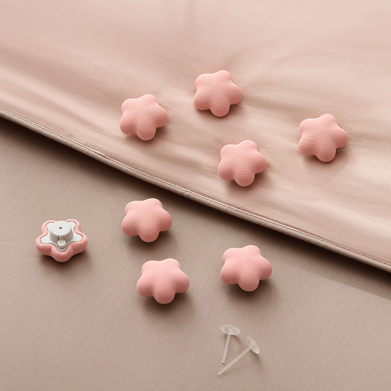 One piece of adorable star and plum blossom shaped comforter clips designed to securely hold duvets in place, prevent slipping, and keep quilts firmly in the corners. These blanket grippers come in pink and should be spot-cleaned only.