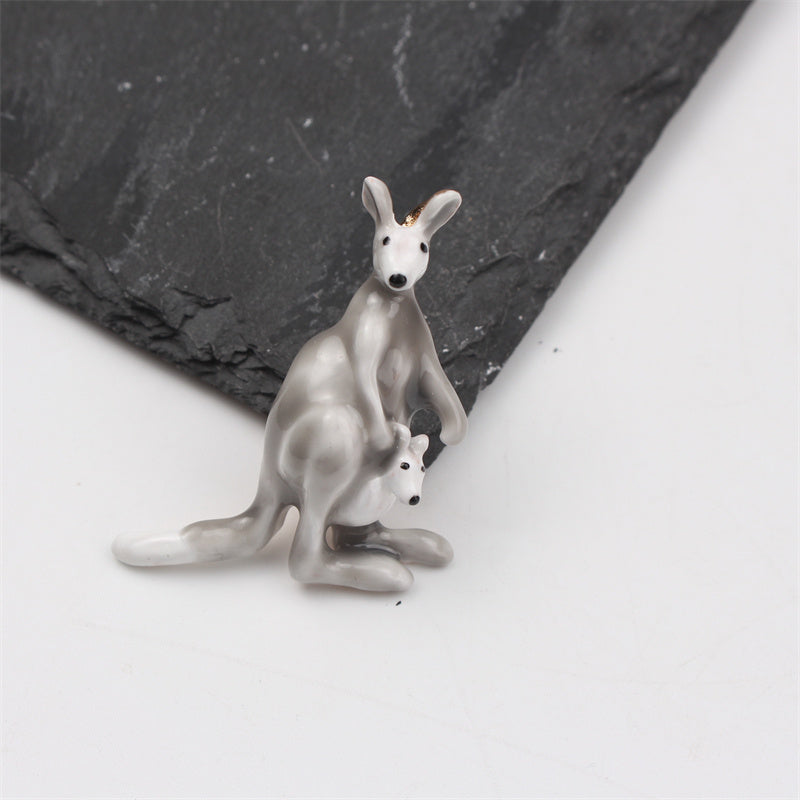 This elegant enamel kangaroo brooch is a cute and unique piece of novelty jewelry in the shape of a cartoon animal. Perfect for both men and women, it features an irregular simulation modeling design that is sure to stand out on any suit coat as a