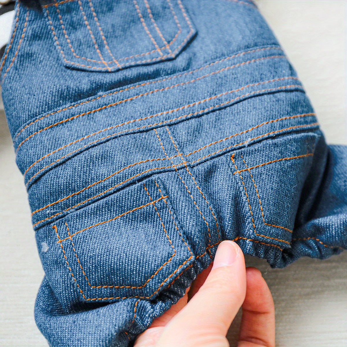 Striped denim jumpsuit for small breeds like Pomeranians and Yorkies, with easy snap closure. Ideal for all seasons.