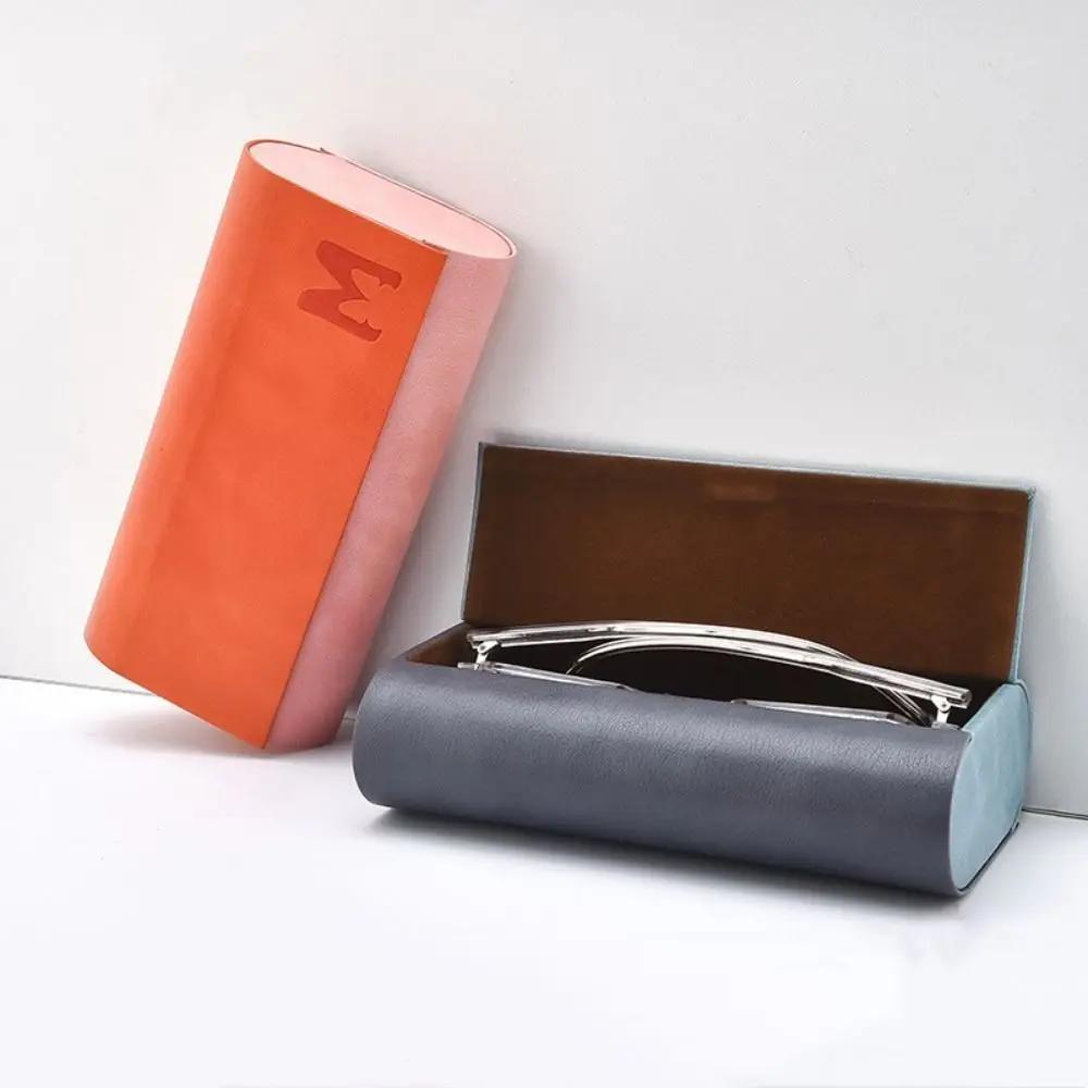 Stylish double-layer glasses case made from durable faux leather. This portable and fashionable case can hold 2 pairs of glasses and comes in scratch-resistant blue or orange.