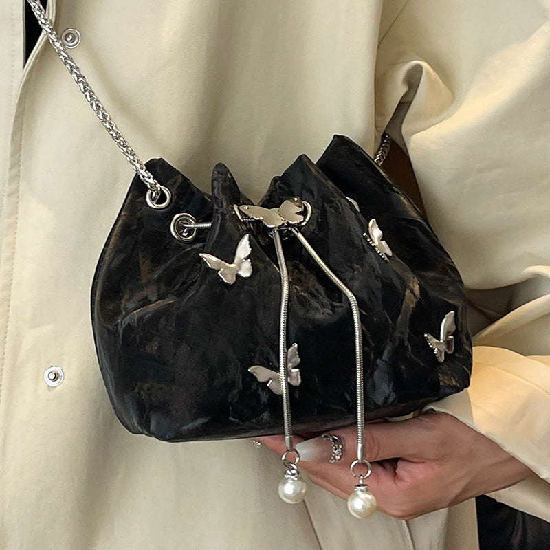 Fashionable women's bucket bag with drawstring closure, available in various colors.