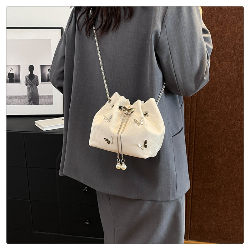 Fashionable women's bucket bag with drawstring closure, available in various colors.