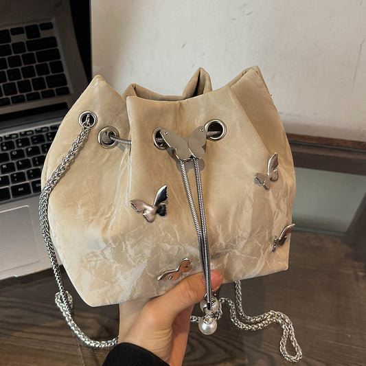 Fashionable women's bucket bag with drawstring closure, available in various colors.