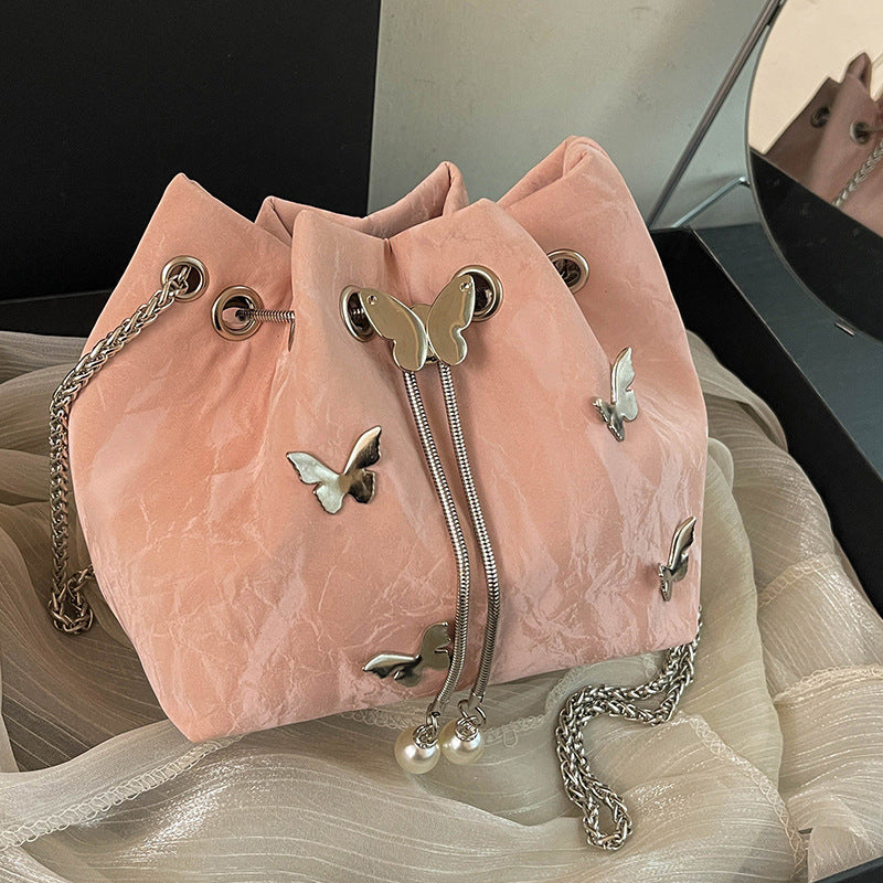 Fashionable women's bucket bag with drawstring closure, available in various colors.