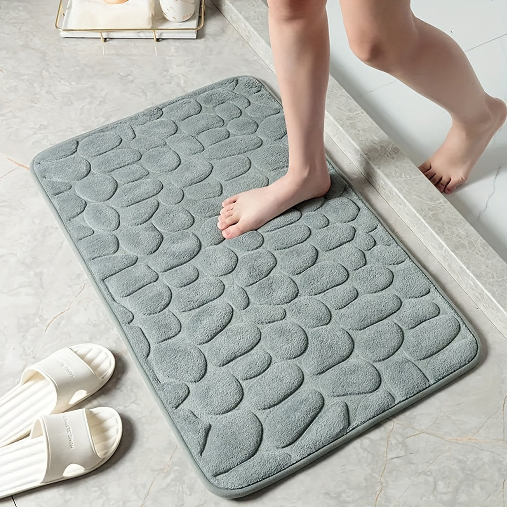 Memory foam bath rug with cobblestone design, ultra-absorbent and anti-slip for home and hotel use. Made of soft coral fleece, this bathroom rug is both practical and stylish.