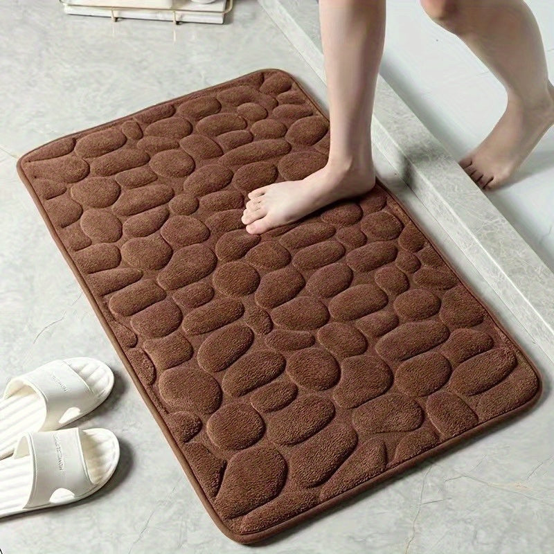 Memory foam bath rug with cobblestone design, ultra-absorbent and anti-slip for home and hotel use. Made of soft coral fleece, this bathroom rug is both practical and stylish.