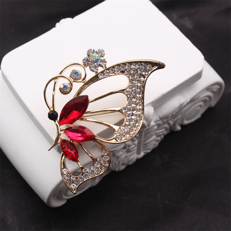 Retro-style brooch corsage coat pin featuring a butterfly and flower design.