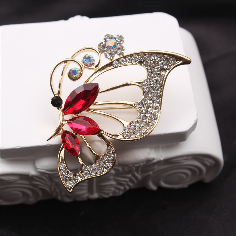 Retro-style brooch corsage coat pin featuring a butterfly and flower design.