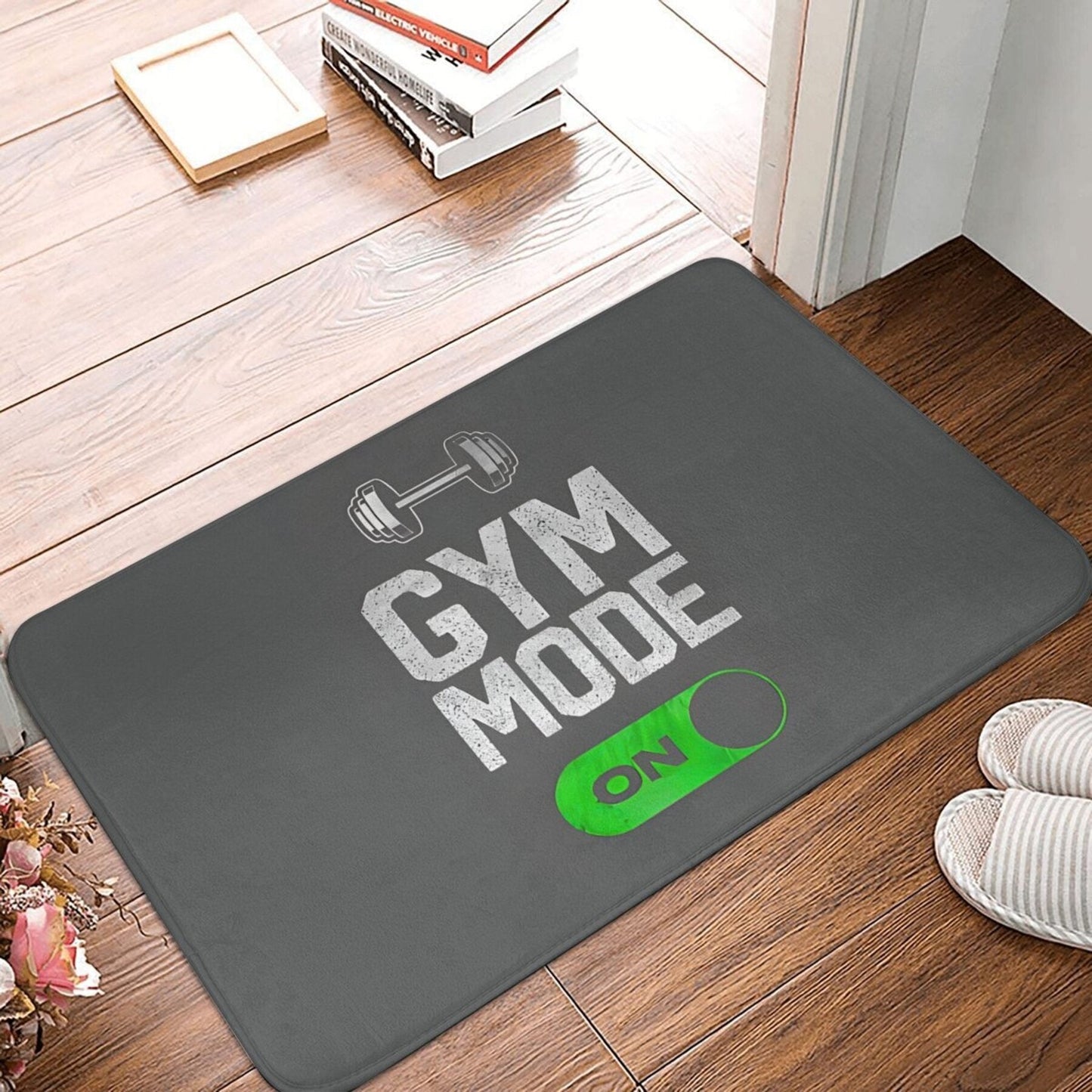 Polyester doormat with non-slip backing that is machine washable. Features a "Gym Mode Activated" design, suitable for bathroom, kitchen, and entrance. This lightweight rectangular floor mat is perfect for home decor.