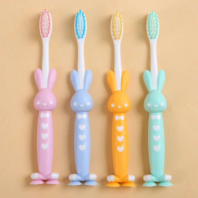 4 soft bristle toothbrushes with bamboo charcoal in cute rabbit and bear designs, pastel colors, and short handles for effective teeth care.