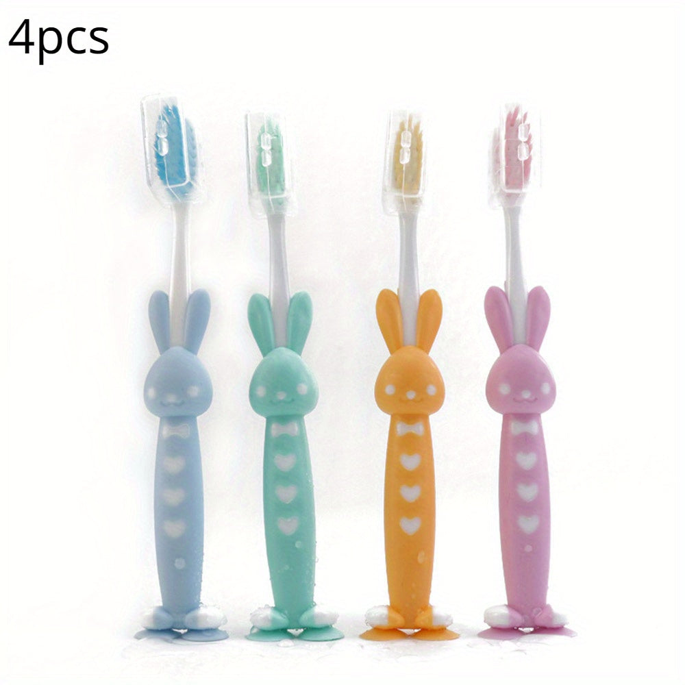 4 soft bristle toothbrushes with bamboo charcoal in cute rabbit and bear designs, pastel colors, and short handles for effective teeth care.