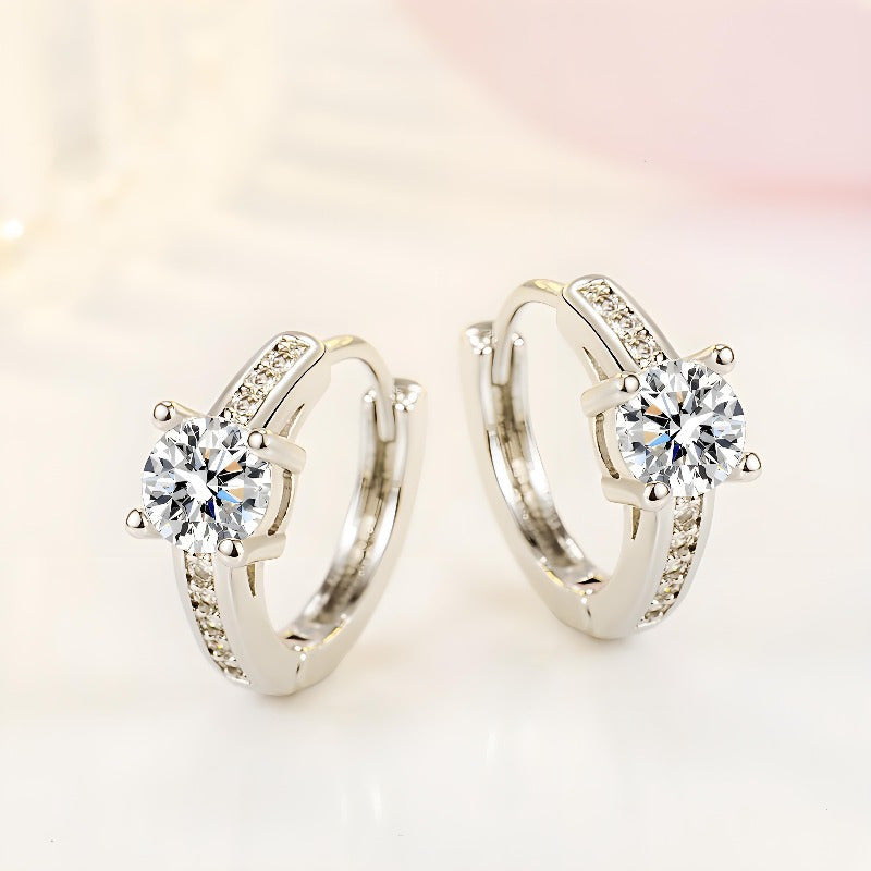 A stylish pair of retro-inspired S925 Silvery earrings, featuring exquisite rhinestones set in round hollow centers. These high-end and trendy accessories boast a luxurious shine, perfect for adding a touch of elegance to any outfit. With a sweet and