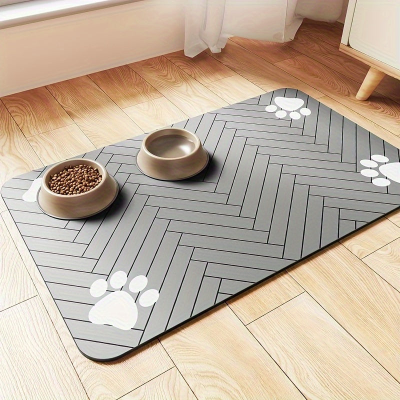 Fast-drying diatomaceous earth pet feeding mat for dogs and cats. Splash-proof, absorbent, easy to clean. Herringbone pattern with paw print design in black. Washable.