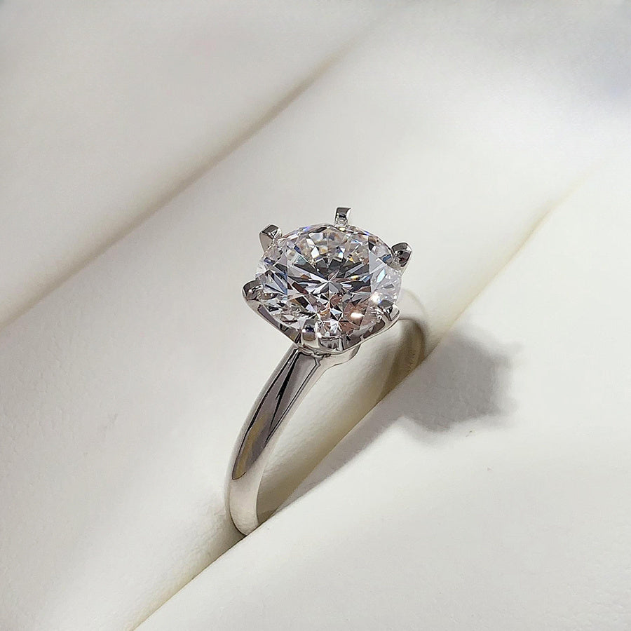 Vintage style wedding band featuring a 10.0 CT six-prong Moissanite stone, representing December birthstone. Made of 925 sterling silver with a glitter-style design, this synthetic diamond ring is silver plated. Perfect for Thanksgiving and all seasonal