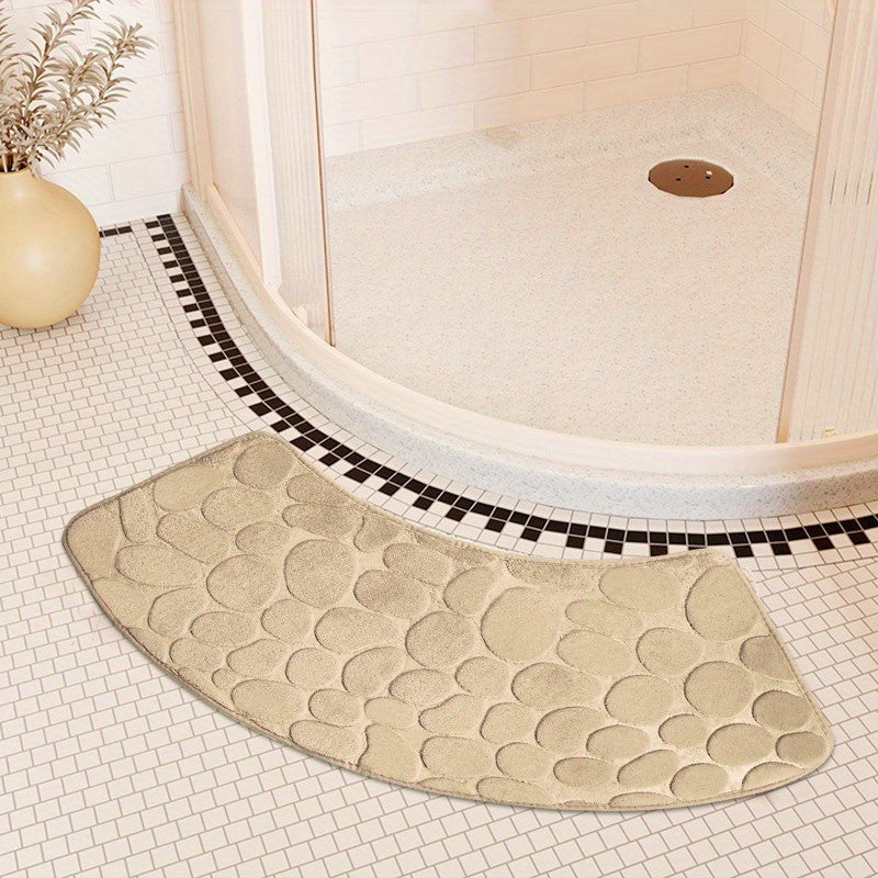 The Pebble Design Memory Foam Bath Mat is a stylish addition to your home, featuring a curved shape for added comfort. This non-slip mat is highly absorbent and can be easily machine washed. Made of thick three-layer flannel, it is perfect for use in the