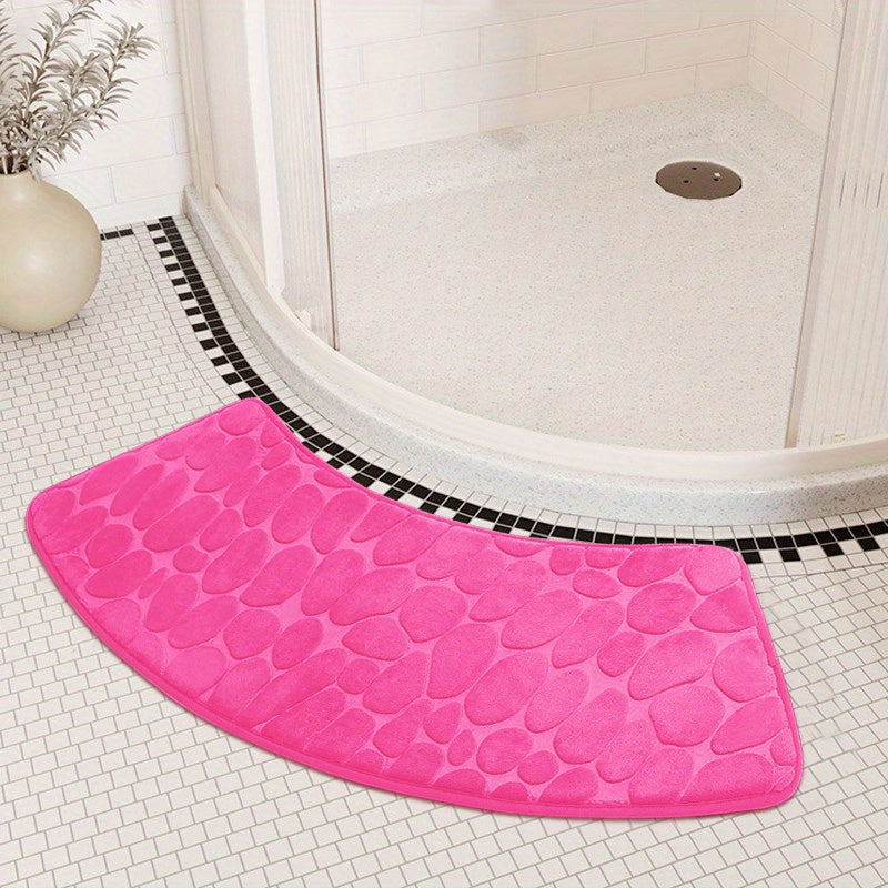 The Pebble Design Memory Foam Bath Mat is a stylish addition to your home, featuring a curved shape for added comfort. This non-slip mat is highly absorbent and can be easily machine washed. Made of thick three-layer flannel, it is perfect for use in the