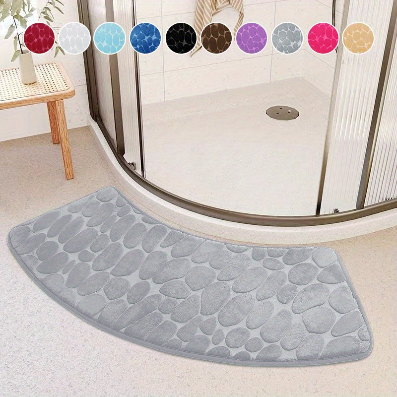 The Pebble Design Memory Foam Bath Mat is a stylish addition to your home, featuring a curved shape for added comfort. This non-slip mat is highly absorbent and can be easily machine washed. Made of thick three-layer flannel, it is perfect for use in the