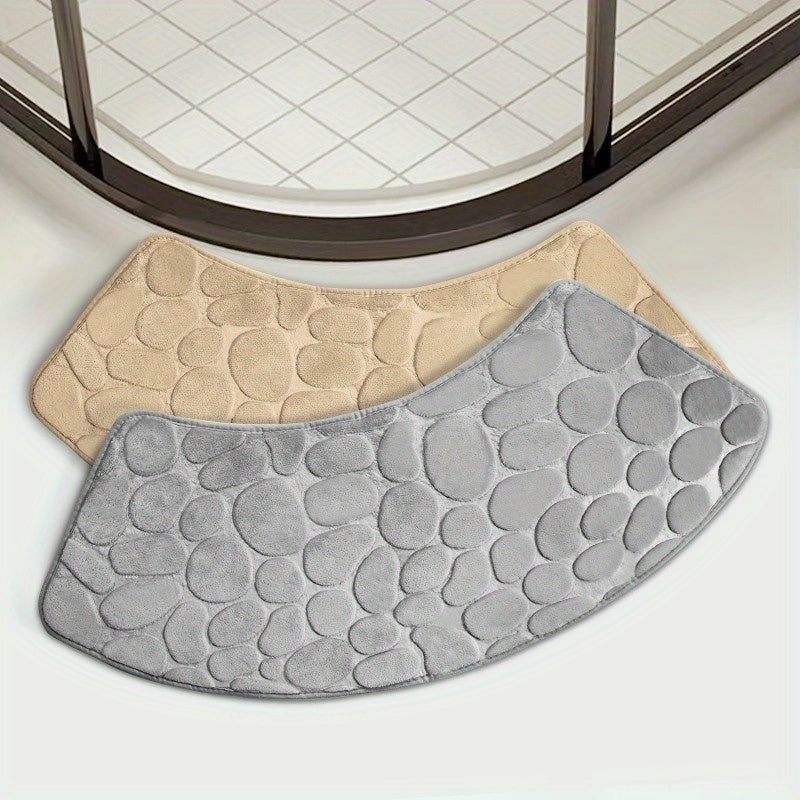 The Pebble Design Memory Foam Bath Mat is a stylish addition to your home, featuring a curved shape for added comfort. This non-slip mat is highly absorbent and can be easily machine washed. Made of thick three-layer flannel, it is perfect for use in the