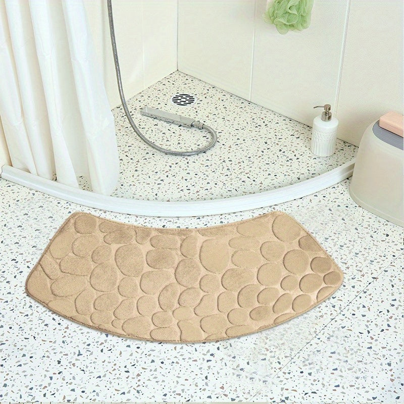 The Pebble Design Memory Foam Bath Mat is a stylish addition to your home, featuring a curved shape for added comfort. This non-slip mat is highly absorbent and can be easily machine washed. Made of thick three-layer flannel, it is perfect for use in the