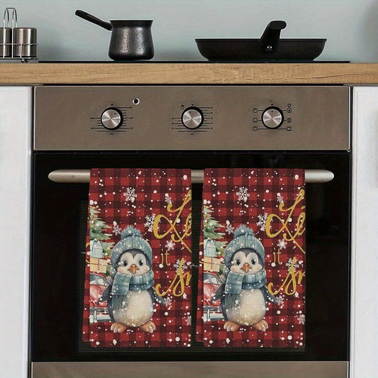 Get a pair of festive kitchen towels with a cute penguin and snowflake design, each measuring 18 by 66.04 cm. Ideal for drying dishes and hands during the holiday season.