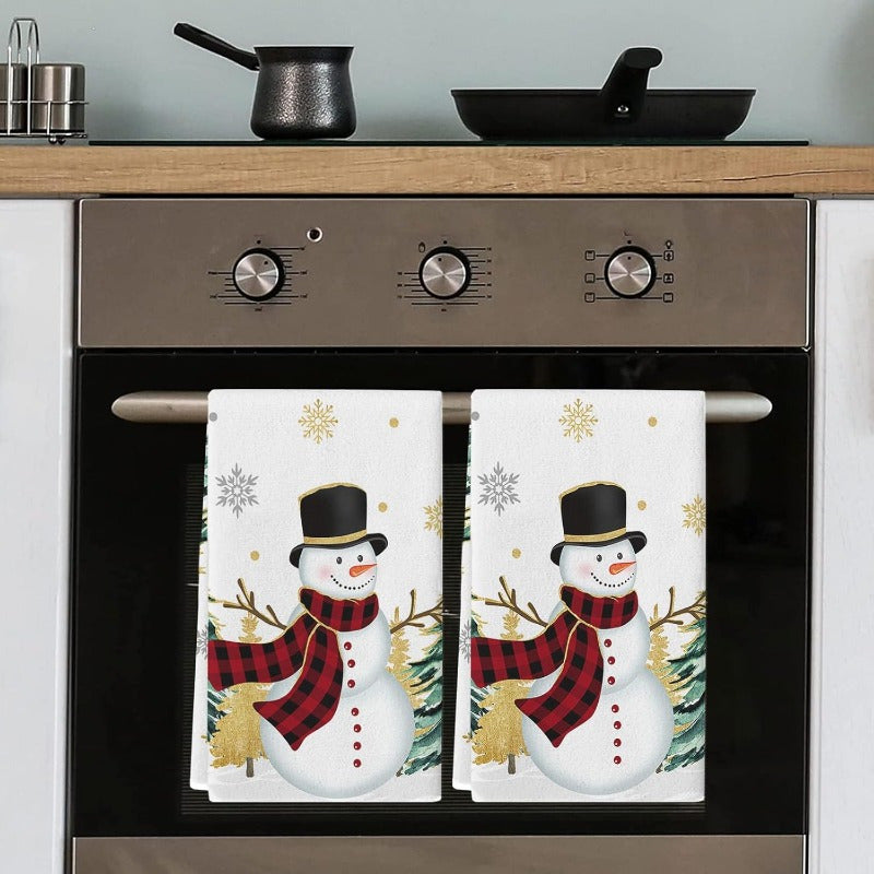 Set of 2 Christmas-themed kitchen towels featuring a snowman, Christmas tree, and golden snowflakes. These towels are highly absorbent, extremely soft, and fast-drying, perfect for use as dish towels, bar towels, or tea towels. Each towel measures