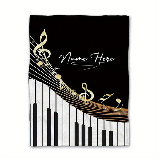 One personalized piano music throw blanket made from soft flannel fleece, featuring your custom name. Lightweight and perfect for use on the sofa, bed, during travel, camping, or in the office chair. The design includes digital print musical notes. This