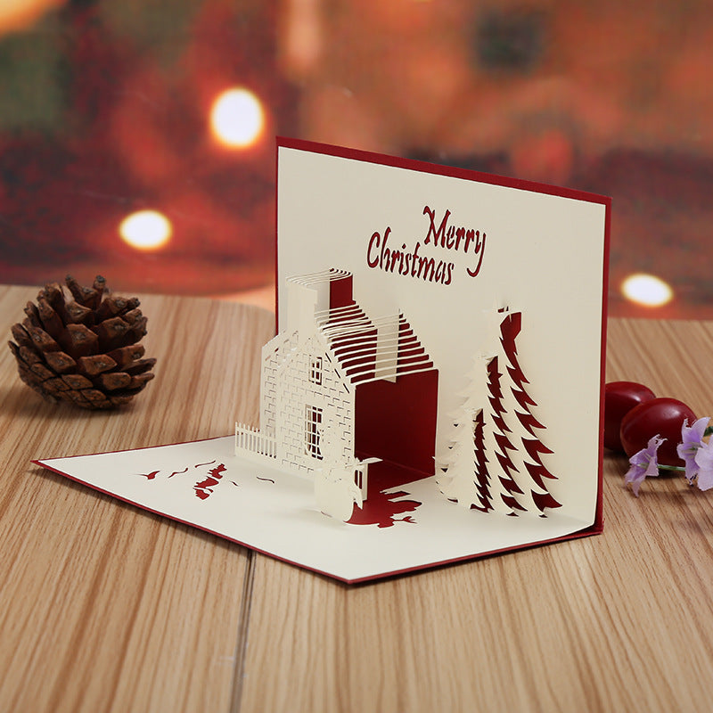 Get into the holiday spirit with this 3D Pop-Up Christmas Card featuring a festive castle and tree design. Made of hollow-out plastic, this unique greeting card is the perfect decoration for the holiday season and New Year's celebration.