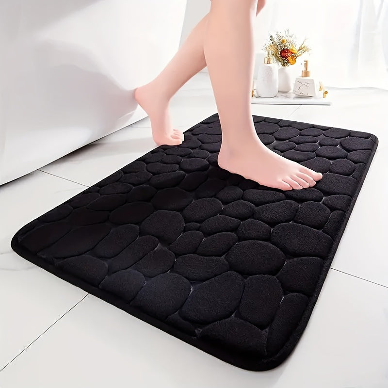 This memory foam bath rug features an embossed cobblestone design and is designed to be super absorbent and non-slip. Made from a polyester blend, it is suitable for use in the bathroom, toilet, kitchen, and laundry. The rug measures 100gsm and is 0.5cm