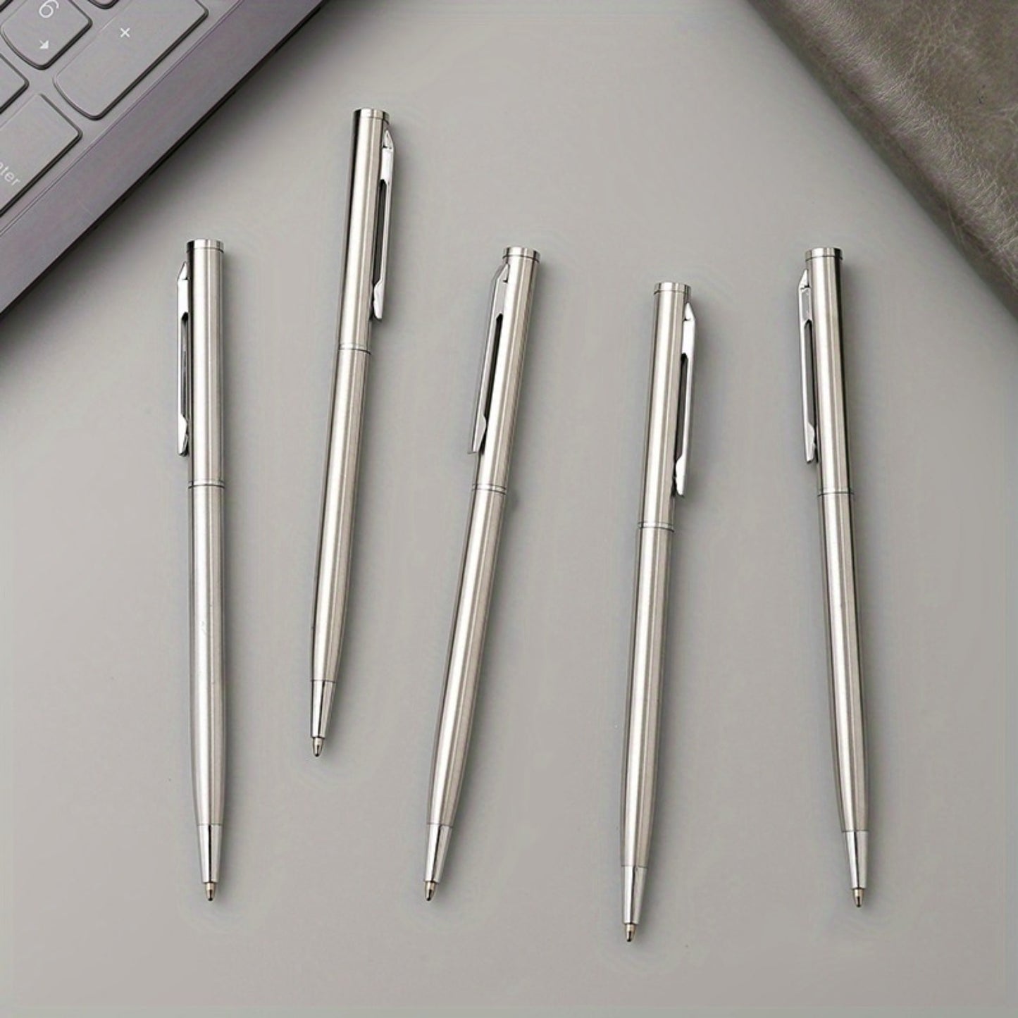 5 sleek silvery stainless steel ballpoint pens with medium point and twist action - ideal for business and office use, school supplies.