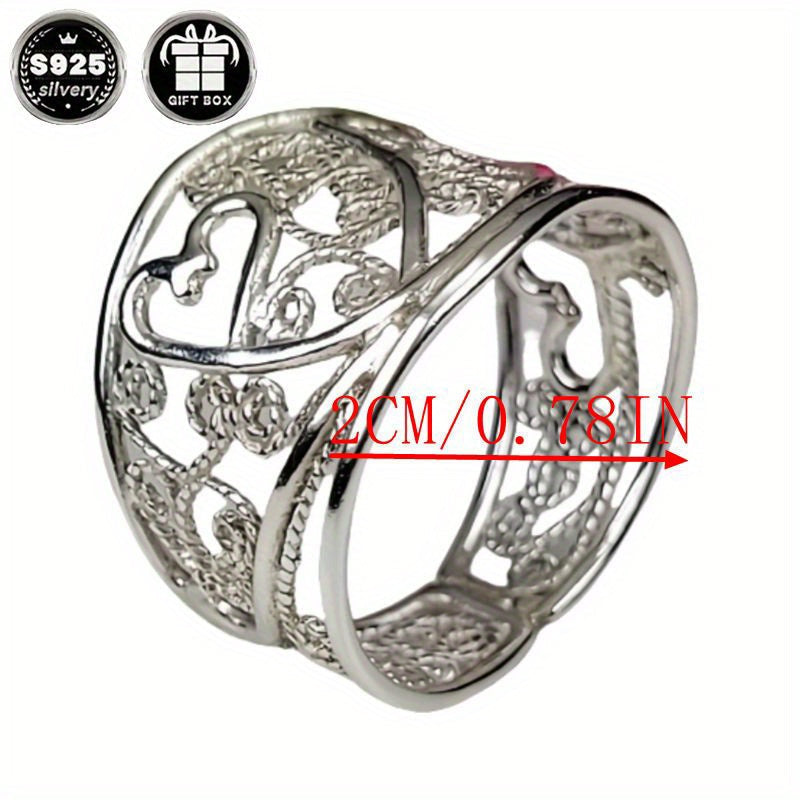 A collection of stylish rings including a delicate filigree design, a bold cigar band, a wide silvery band, a heart-shaped ring made of 925 sterling silver, a thick silvery band, and a bohemian-style ring. This filigree art jewelry is perfect for adding