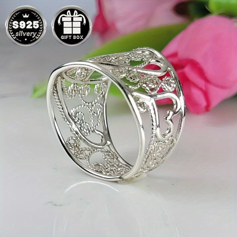 A collection of stylish rings including a delicate filigree design, a bold cigar band, a wide silvery band, a heart-shaped ring made of 925 sterling silver, a thick silvery band, and a bohemian-style ring. This filigree art jewelry is perfect for adding