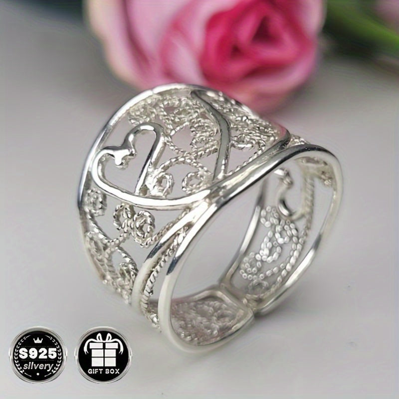 A collection of stylish rings including a delicate filigree design, a bold cigar band, a wide silvery band, a heart-shaped ring made of 925 sterling silver, a thick silvery band, and a bohemian-style ring. This filigree art jewelry is perfect for adding