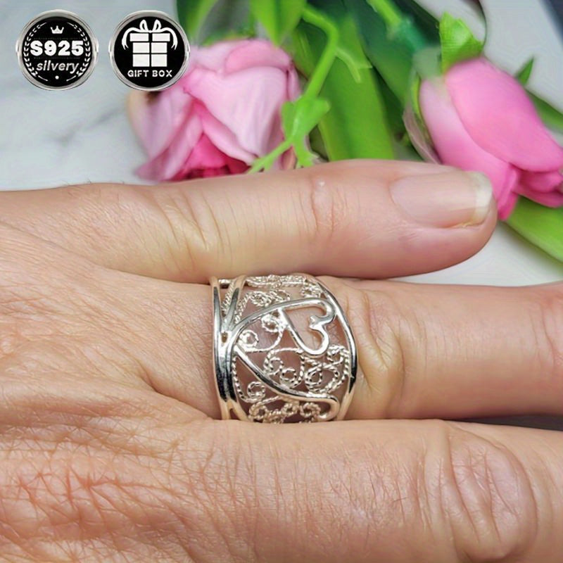 A collection of stylish rings including a delicate filigree design, a bold cigar band, a wide silvery band, a heart-shaped ring made of 925 sterling silver, a thick silvery band, and a bohemian-style ring. This filigree art jewelry is perfect for adding