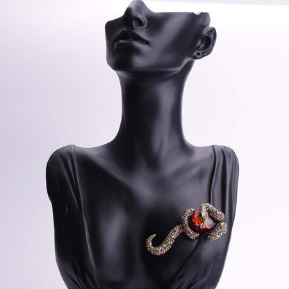 Luxurious punk style enamel snake brooch featuring stunning inlaid zirconia, perfect for both men and women. This unique animal pin adds a touch of irregular shape fashion to any party or banquet outfit. Ideal accessory for a stylish suit or coat.