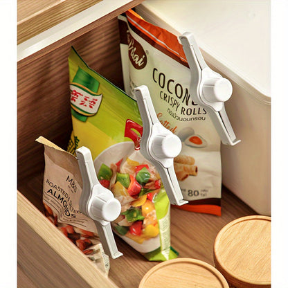 Set of 3 plastic clips with pour spouts for sealing bags, perfect for non-food items. Keep your snacks fresh and dry with these convenient twist cap dispensers. Great for organizing your kitchen storage with cereal and coffee pouches.