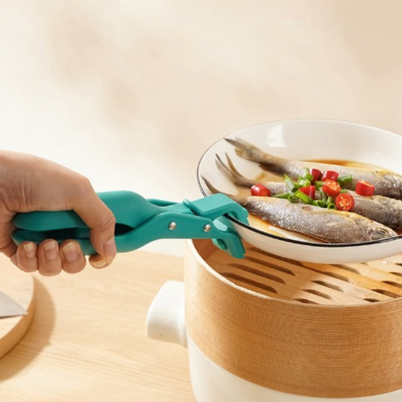 Two pieces of heat-resistant silicone potato clips that are designed to securely grip dishes without slipping. These kitchen utensils are ideal for handling hot food, as well as lifting plastic bowls and pans with ease.