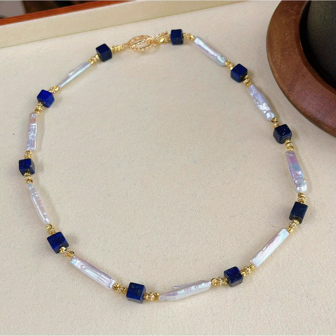 A sophisticated necklace with a vintage charm, featuring Baroque pearls and Lapis Lazuli stones in a Bohemian style. Made with natural freshwater pearls showcasing unique growth flaws, this piece is a stunning addition to any women's fashion collection.