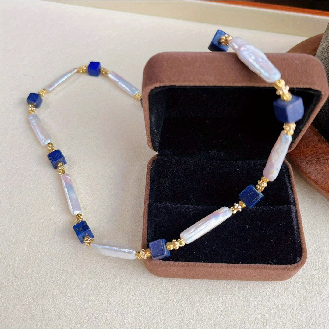 A sophisticated necklace with a vintage charm, featuring Baroque pearls and Lapis Lazuli stones in a Bohemian style. Made with natural freshwater pearls showcasing unique growth flaws, this piece is a stunning addition to any women's fashion collection.