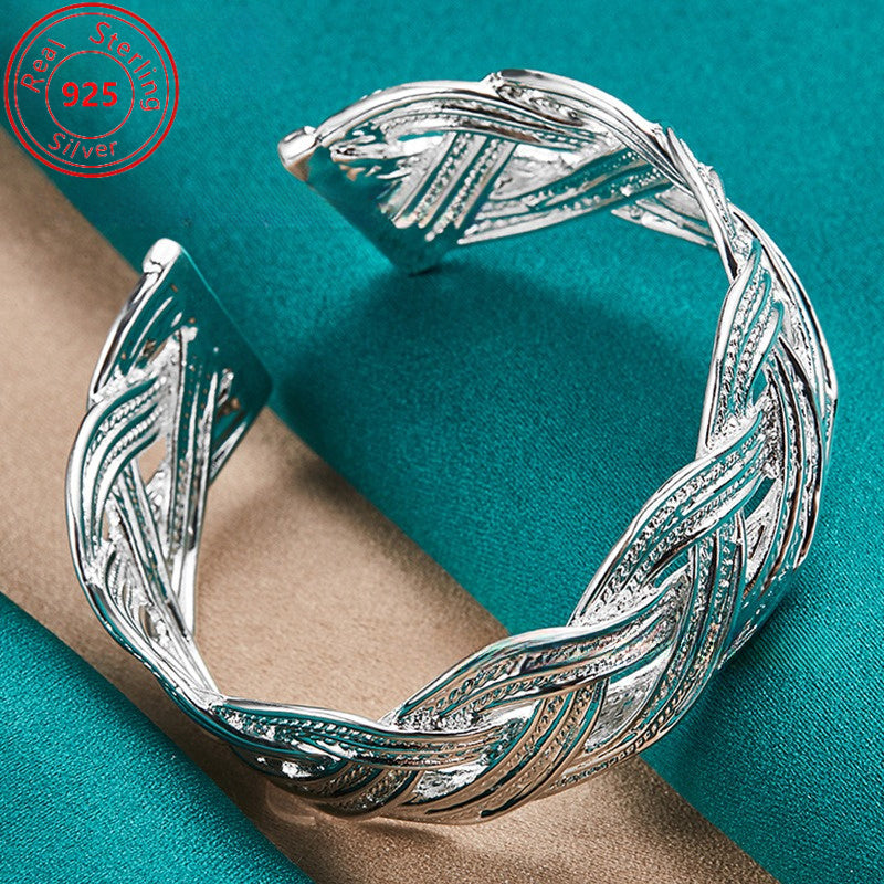 This bracelet is made of 925 sterling silver and features a woven design that is both stylish and elegant. It is adjustable and perfect for everyday wear, parties, birthdays, and Thanksgiving. This trendy piece of jewelry is a perfect gift for any female