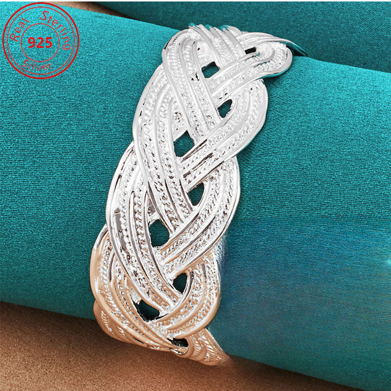 This bracelet is made of 925 sterling silver and features a woven design that is both stylish and elegant. It is adjustable and perfect for everyday wear, parties, birthdays, and Thanksgiving. This trendy piece of jewelry is a perfect gift for any female