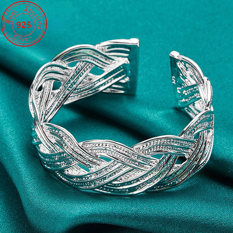 This bracelet is made of 925 sterling silver and features a woven design that is both stylish and elegant. It is adjustable and perfect for everyday wear, parties, birthdays, and Thanksgiving. This trendy piece of jewelry is a perfect gift for any female